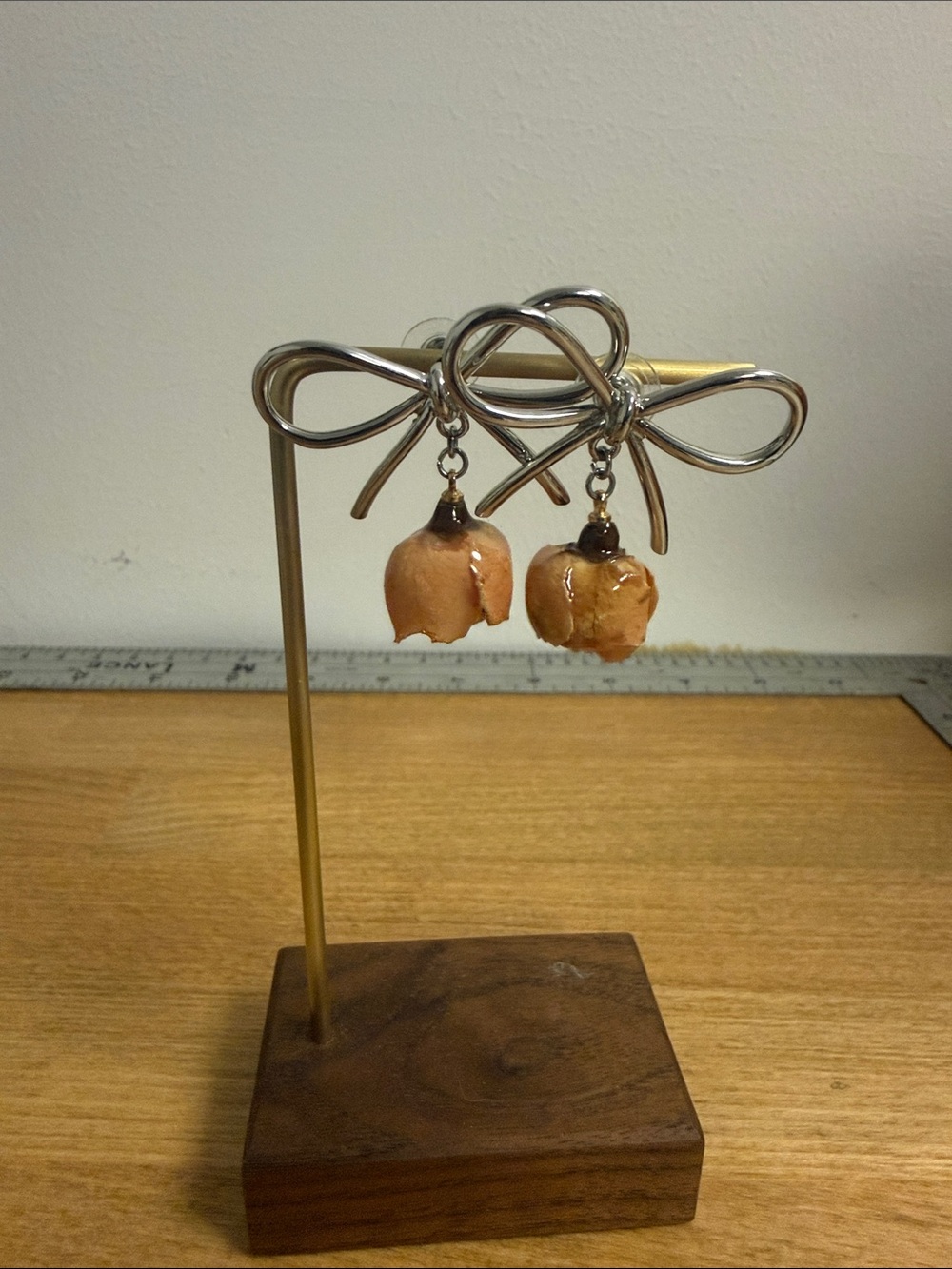 Silver tone large bow earrings with 3d drop rose accent flower